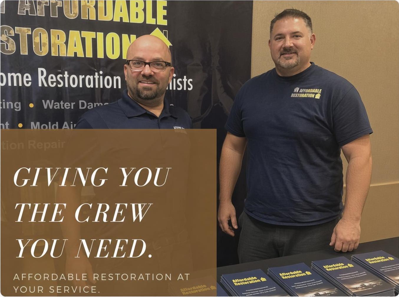 Two Affordable Restoration team members at a company display.