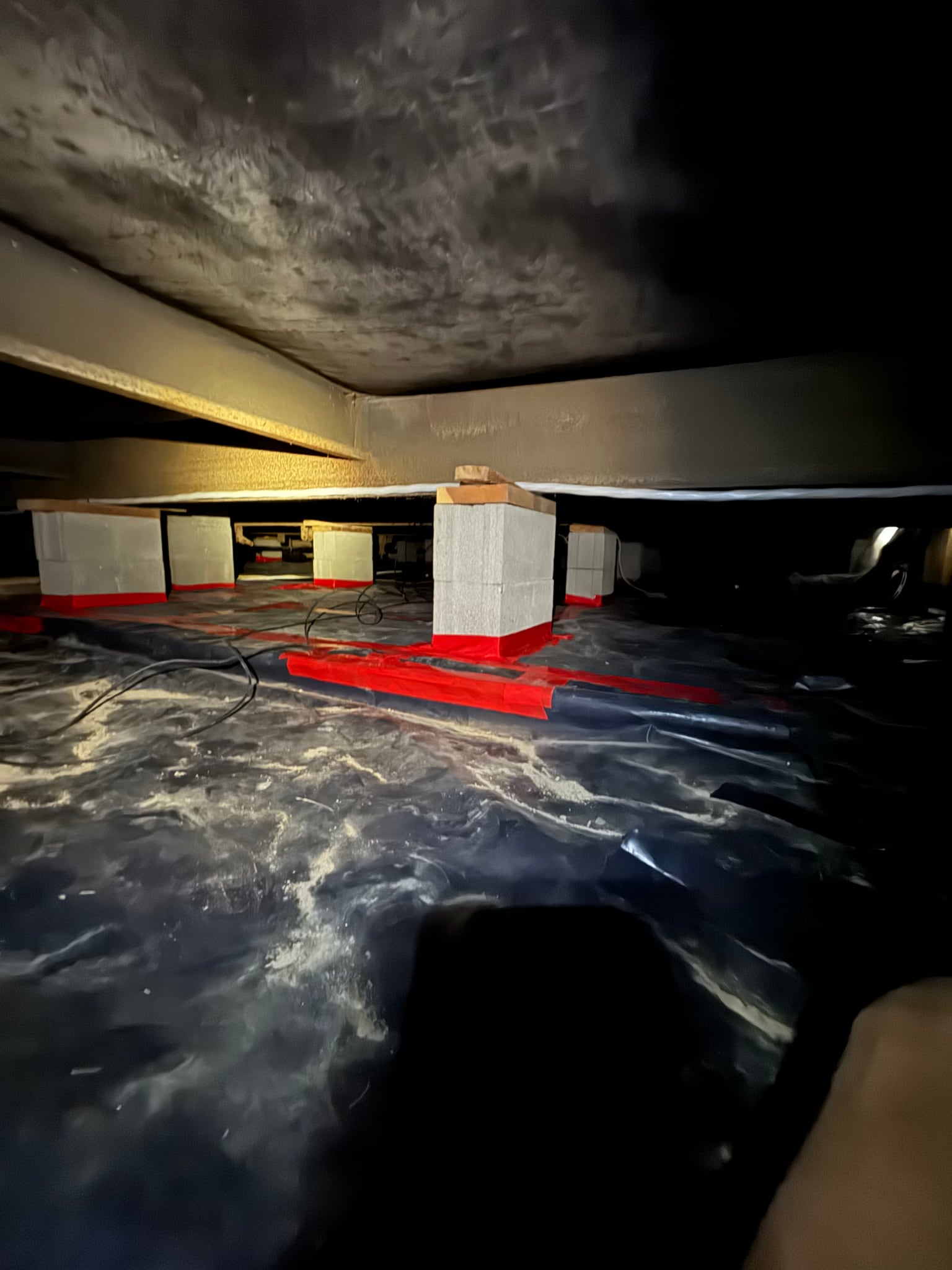 Crawl space with a floor barrier and support piers