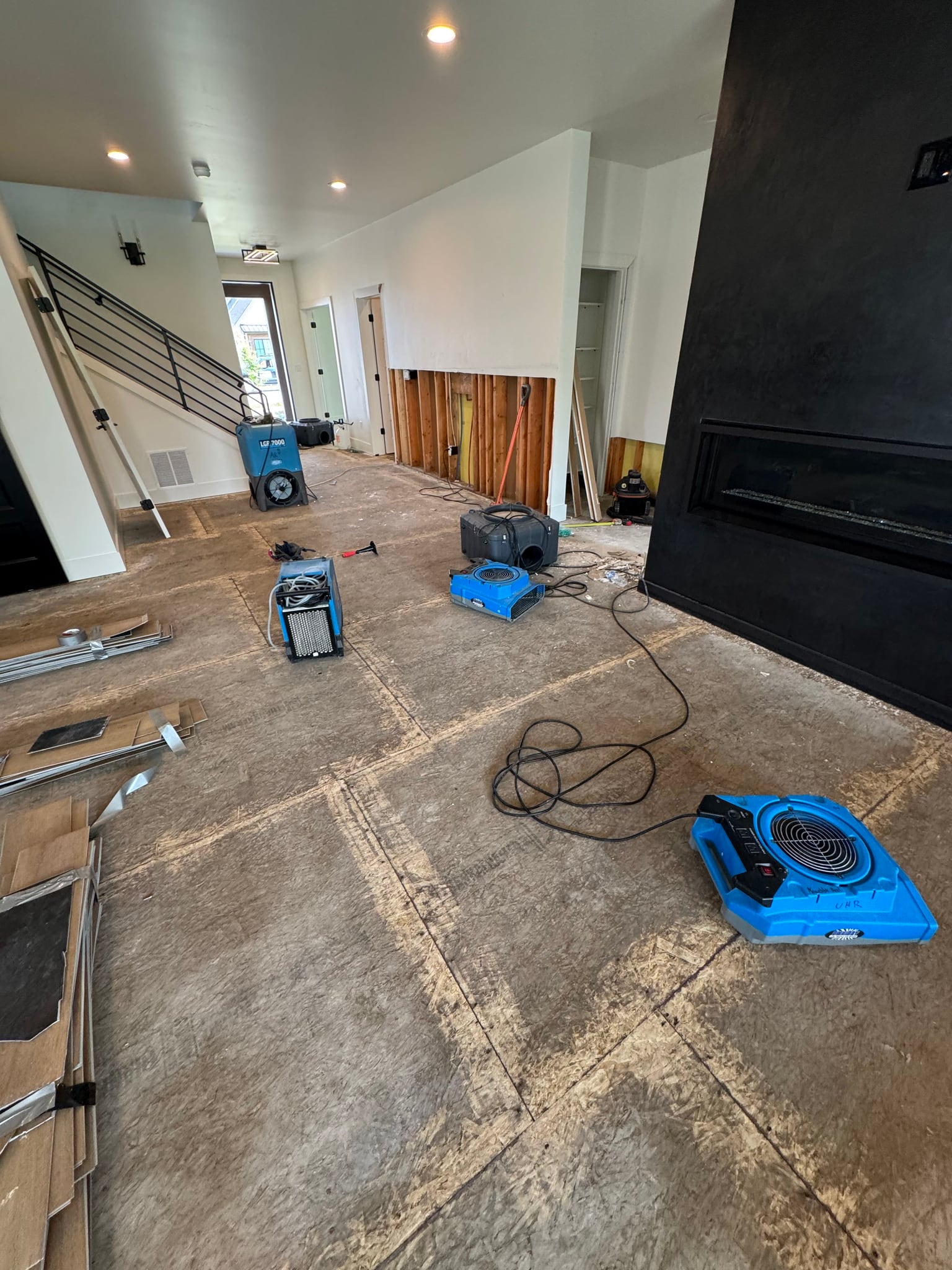 Drying equipment set up in a room with exposed flooring